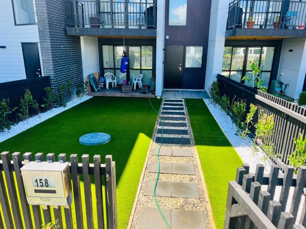 Installed artificial lawn with stepping stones and planted borders in New Lynn, Auckland